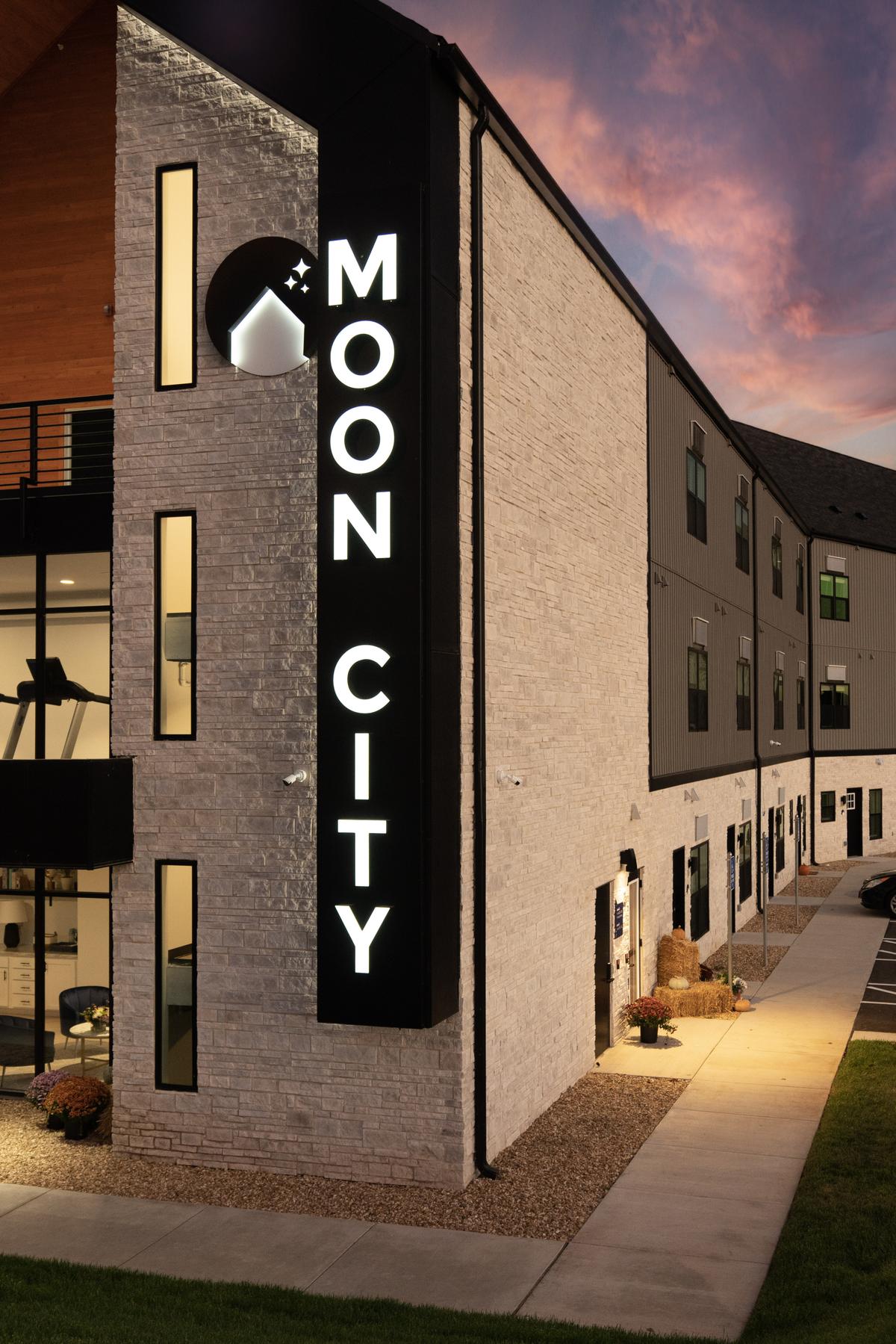 Vertical MOON CITY sign and stone corner, portrait